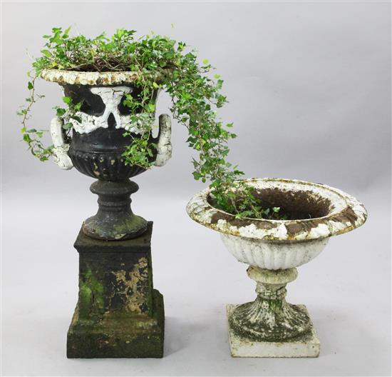 A Victorian two handled cast iron garden urn & another urn